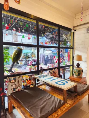 a room with a bench in front of a window at Back Home Backpackers Hostel in Bangkok