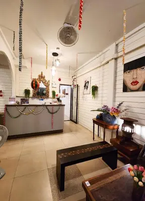 a lobby of a restaurant with a counter and a table at Back Home Backpackers Hostel in Bangkok