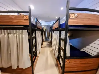 a row of bunk beds in a room at Back Home Backpackers Hostel in Bangkok