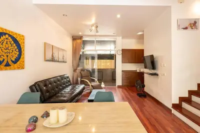 a living room with a couch and a table at 420 House- up to 10 guests in central Bangkok. in Bangkok