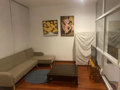 a living room with a couch and a table at 420 House- up to 10 guests in central Bangkok. in Bangkok