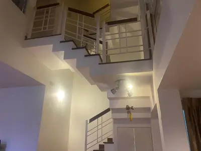 a staircase in a house with a white stair case at 420 House- up to 10 guests in central Bangkok. in Bangkok