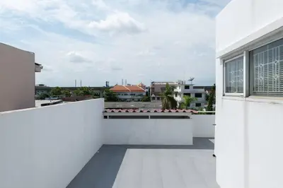 a white balcony with a view of a city at 420 House- up to 10 guests in central Bangkok. in Bangkok