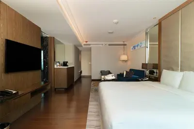 a hotel room with a bed and a flat screen tv at Radisson Blu Plaza Bangkok in Bangkok
