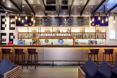 a bar in a restaurant with bar stools at Radisson Blu Plaza Bangkok in Bangkok