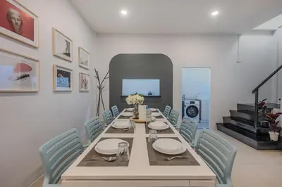 a dining room with a table and blue chairs at Spacious Haven Chatuchak Market 5BR 10 Sleeps RB1 in Ban Zong Katiam