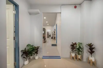 a hallway with potted plants in a building at Spacious Haven Chatuchak Market 5BR 10 Sleeps RB1 in Ban Zong Katiam
