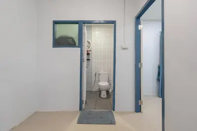 an open door to a bathroom with a toilet at Spacious Haven Chatuchak Market 5BR 10 Sleeps RB1 in Ban Zong Katiam