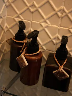 a group of three bottles of chocolate on a table at The Bhuthorn Bed & Breakfast in Bangkok