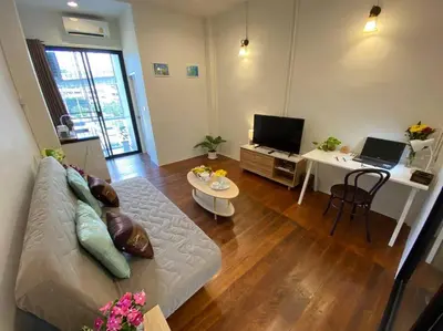 a living room with a couch and a table at 1 min walk to BTS, 3 Bed 3 Bath, Entire House in Bangkok