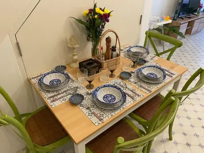 a table with blue and white plates and a basket on it at 1 min walk to BTS, 3 Bed 3 Bath, Entire House in Bangkok