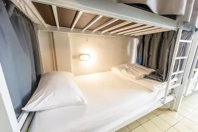 a small room with two bunk beds in it at PICCOLO SUKHUMVIT HOSTEL- Self check-in after 6 pm in Bangkok