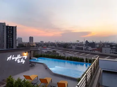 a swimming pool on the roof of a building at Lumen Bangkok Udomsuk Station in Bangkok
