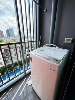 a washing machine in a room with a large window at Monte Rama 9 near JodFair Market Condo in Bangkok