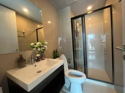 a bathroom with a sink and a toilet and a shower at Monte Rama 9 near JodFair Market Condo in Bangkok