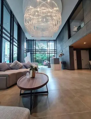 a large living room with a couch and a table at Monte Rama 9 near JodFair Market Condo in Bangkok