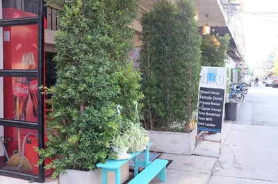 a group of potted plants on the side of a building at PLOY Hostel in Bangkok