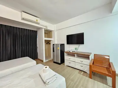 a hotel room with a bed and a television at Crown BTS Nana Hotel in Bangkok