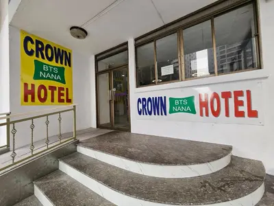 a hotel with signs on the side of a building at Crown BTS Nana Hotel in Bangkok