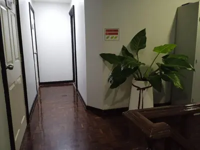 a hallway with a vase with a plant in it at NK Guesthouse 1 in Khlong Toei