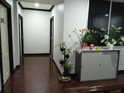 a hallway with potted plants in a room at NK Guesthouse 1 in Khlong Toei