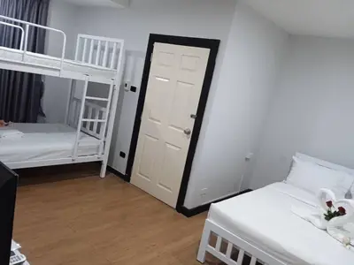 a room with two bunk beds and a door at NK Guesthouse 1 in Khlong Toei