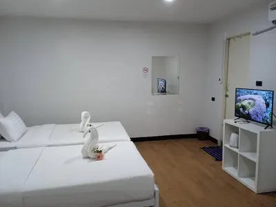 a room with a bed with a stuffed rabbit on it at NK Guesthouse 1 in Khlong Toei