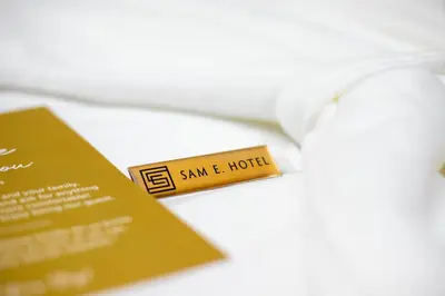 a tag that says sam and hotel next to a ticket at SAM E Hotel Bangkok Sathorn in Bangkok