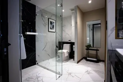 a bathroom with a glass shower and a toilet at SAM E Hotel Bangkok Sathorn in Bangkok