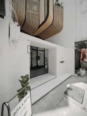 a lobby of a building with a ceiling at Double B Hostel in Bangkok