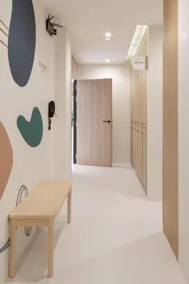 a hallway with a bench and a door at Double B Hostel in Bangkok