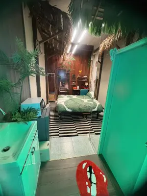 a bedroom with a bed in the middle of a room at New York Loft & Japanese Magic by V4SKIN in Bangkok