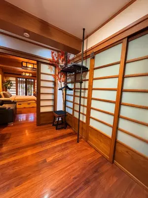 a living room with wood paneling and wooden floors at New York Loft & Japanese Magic by V4SKIN in Bangkok