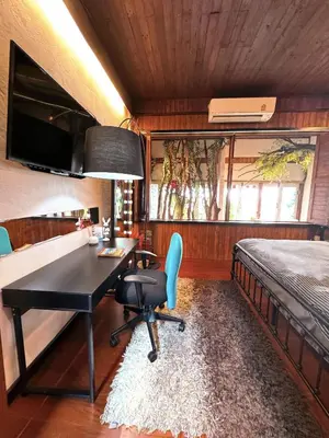 a bedroom with a bed and a desk and a beduten at New York Loft & Japanese Magic by V4SKIN in Bangkok