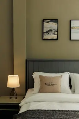 a bedroom with a bed and three pictures on the wall at Casa Luna in Bangkok