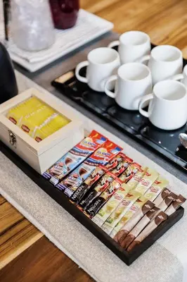 a tray with magazines and cups on a table at Casa Luna in Bangkok