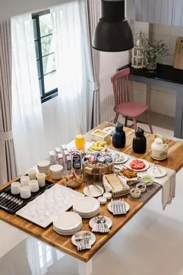 a table with food on it in a kitchen at Casa Luna in Bangkok