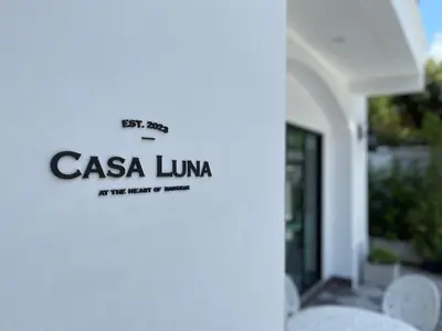 a sign on the side of a building at Casa Luna in Bangkok