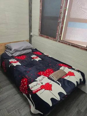 a bed in a room with a cow blanket at 206 Lovely Room with cool fan with full amenities & Free Wi-Fi in Bangkok