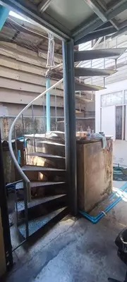 a set of stairs in a building with a chair at 206 Lovely Room with cool fan with full amenities & Free Wi-Fi in Bangkok