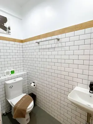 a white bathroom with a toilet and a sink at Unwind in oldtown, private floor, near Grand Palace in Bangkok