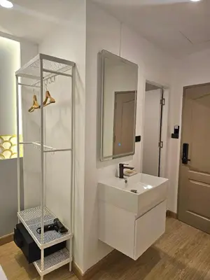 a white bathroom with a sink and a mirror at Arawana Express Sukhumvit 22 in Bangkok