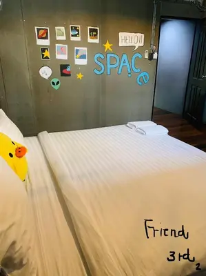 a bed with a comforter on top of it at Enterspace Chinatown in Khlong San