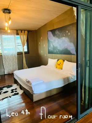 a bedroom with a bed with a yellow pillow on it at Enterspace Chinatown in Khlong San