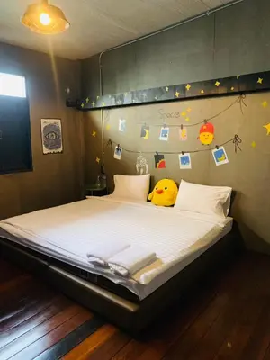 a bedroom with a bed with two towels on it at Enterspace Chinatown in Khlong San