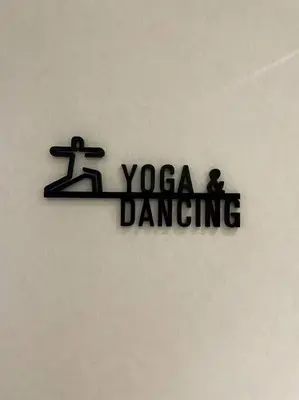 a sign that says yoga dancing on a wall at Luxury River View in Bangkok