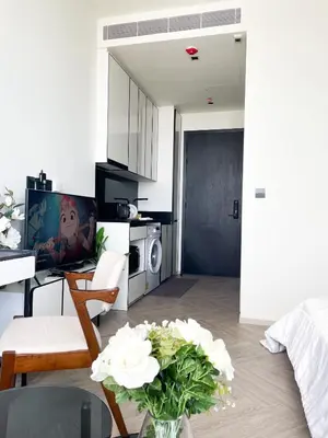 a living room with a couch and a table with flowers at Luxury River View in Bangkok