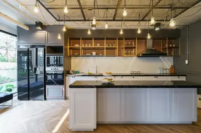 a kitchen with white cabinets and a large island at \u6c99\u541eSathon-Charoen Nakhon\u7cbe\u54c1\u516c\u5bd3 in Bangkok