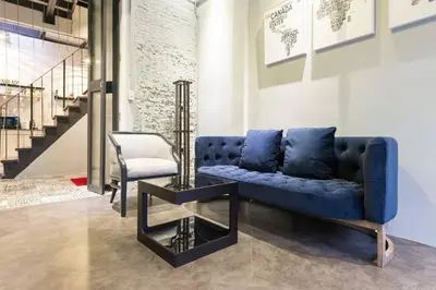 a blue couch and a chair in a room at Inner Old Town 196 Chic Guesthouse - self check in in Bangkok