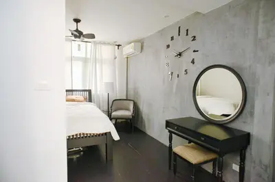 a bedroom with a mirror and a bed and a table at Inner Old Town 196 Chic Guesthouse - self check in in Bangkok